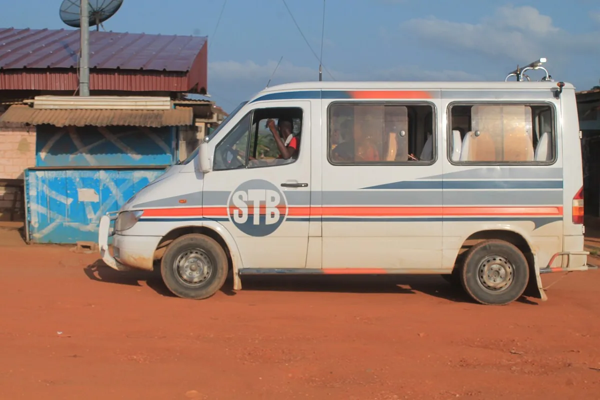 Chauffeur beside a private vehicle